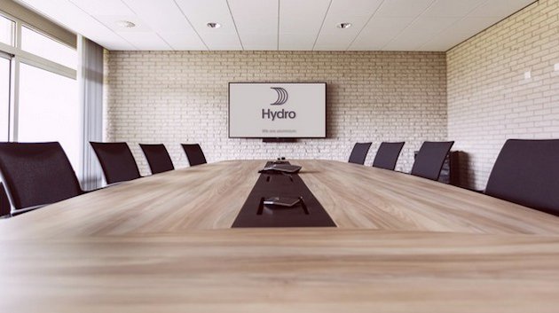 Conference room with large table, chairs and a monitor Conference room with large table, chairs and a monitor