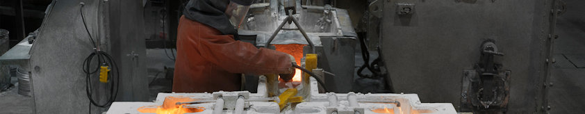 Man woking with liquid aluminium in a casthouse