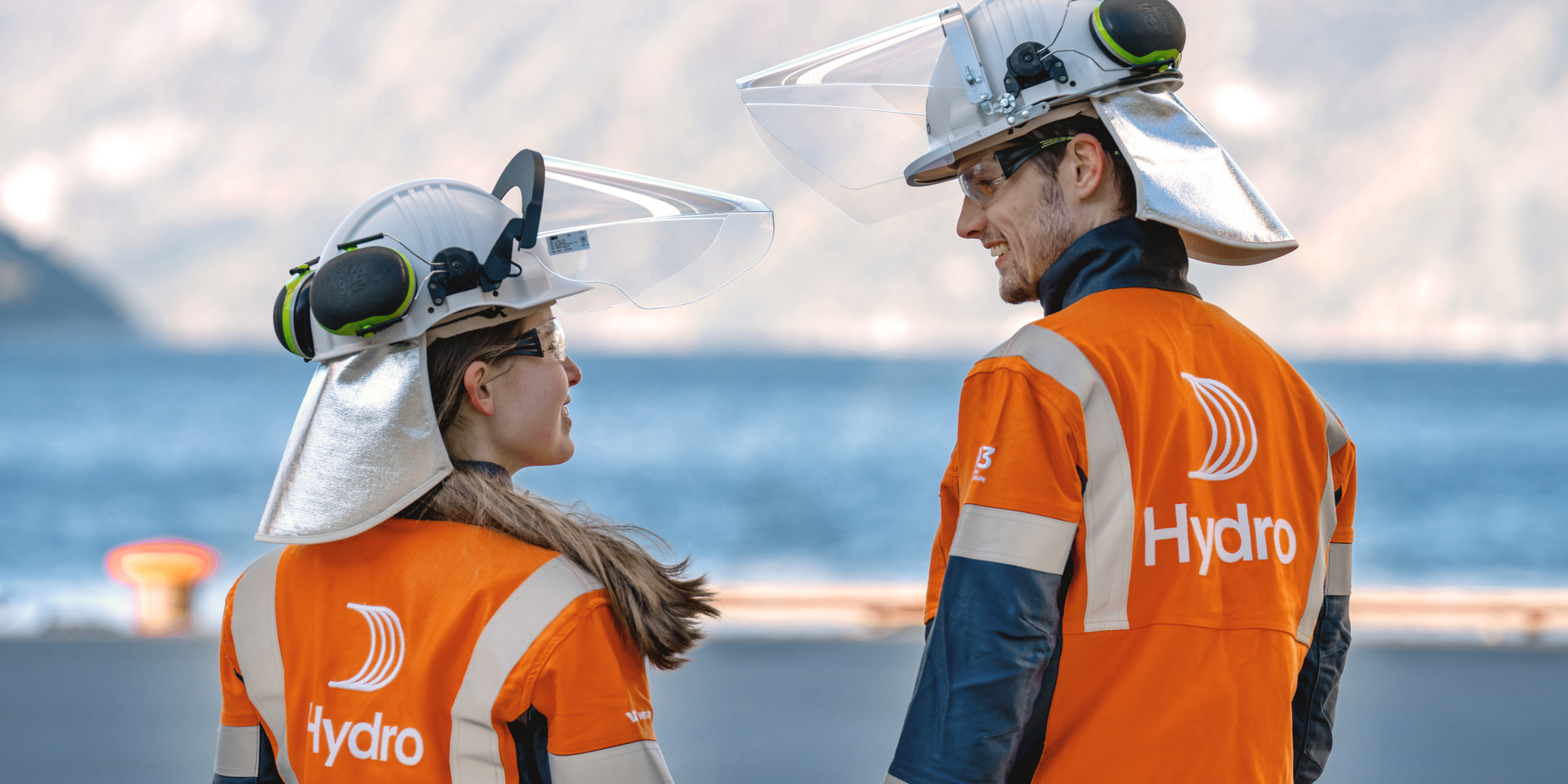 a man and woman wearing helmets