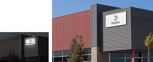 facade signage illuminated from above at night, in daylight without illumination