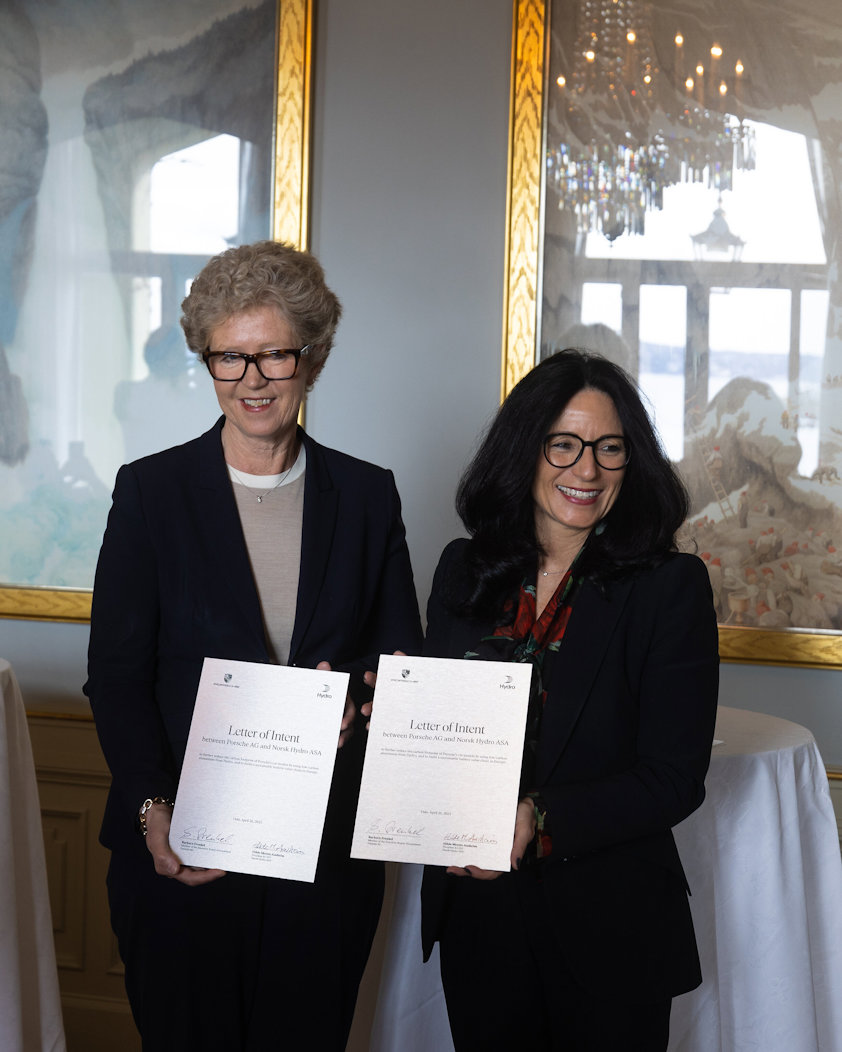 two woman holding papers