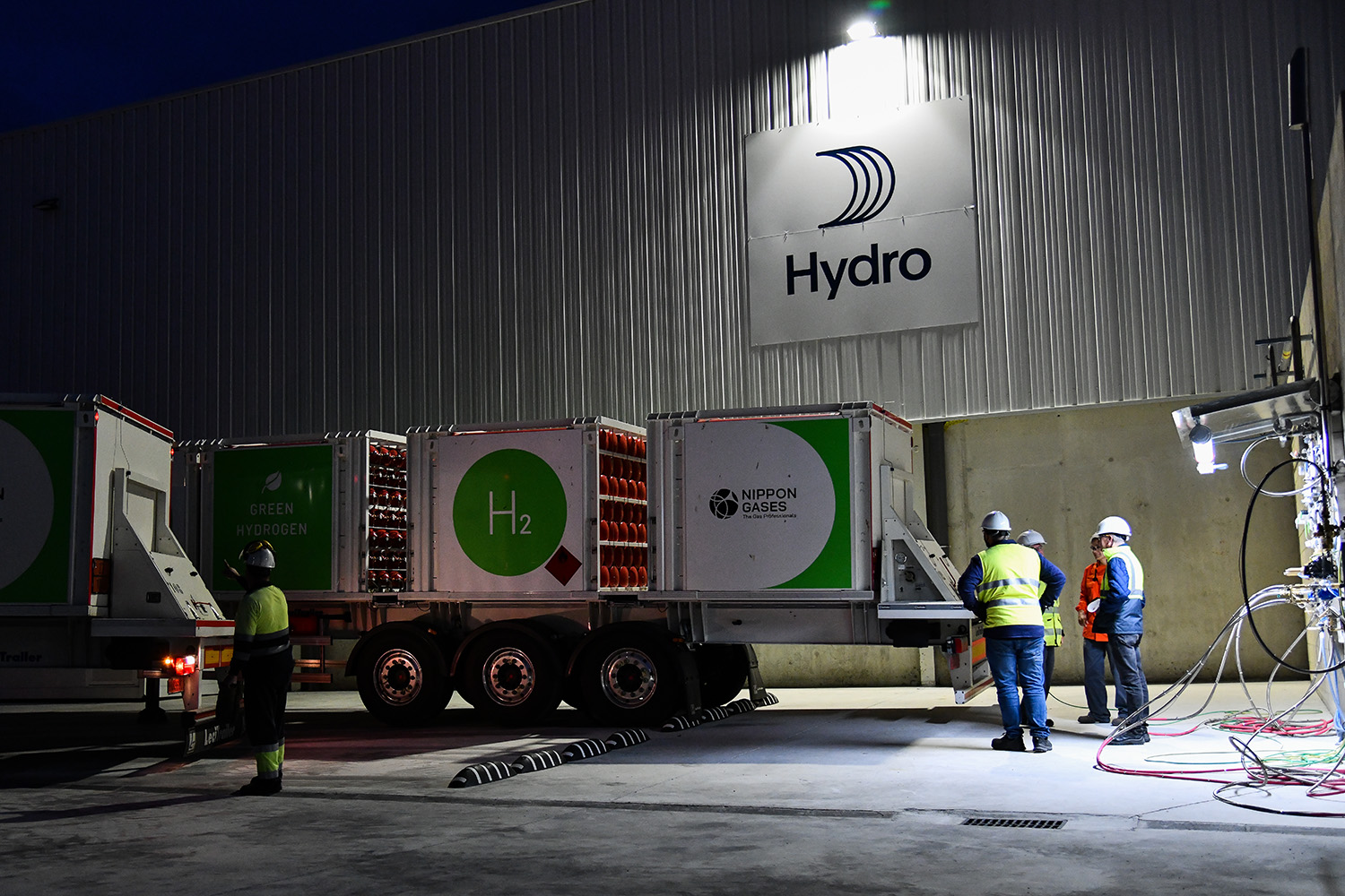 a group of men standing next to a large truck