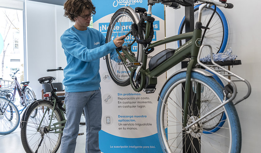 a person standing next to a bicycle a person standing next to a bicycle