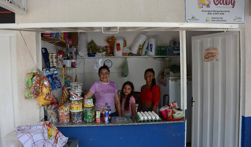 a group of people posing for a photo in a kitchen a group of people posing for a photo in a kitchen