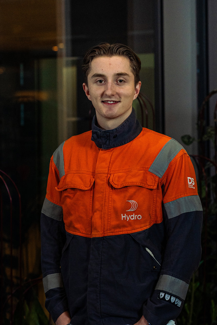 a man in an orange and black overalls