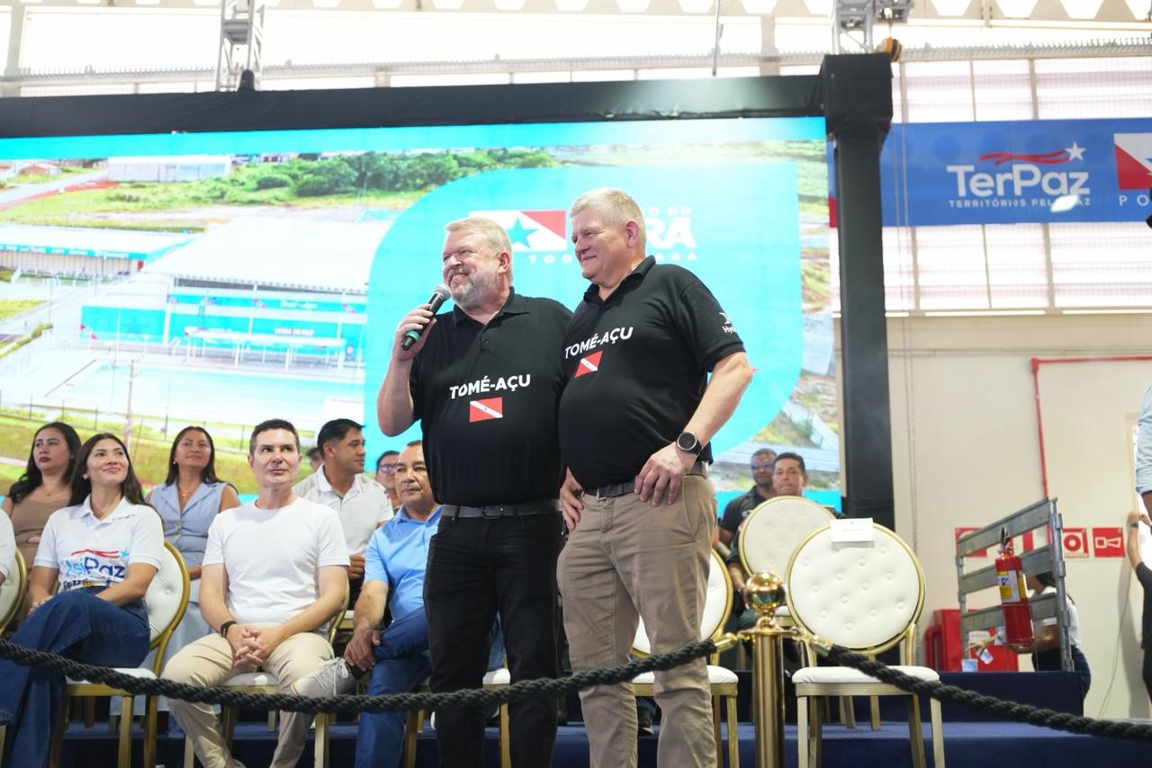 two men standing on a stage