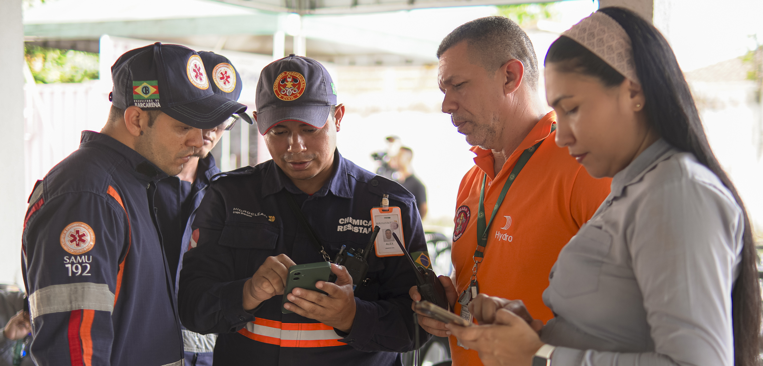 a group of people looking at a cellphone
