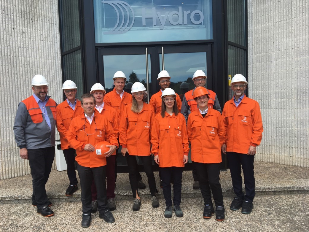 a group of people wearing orange jackets