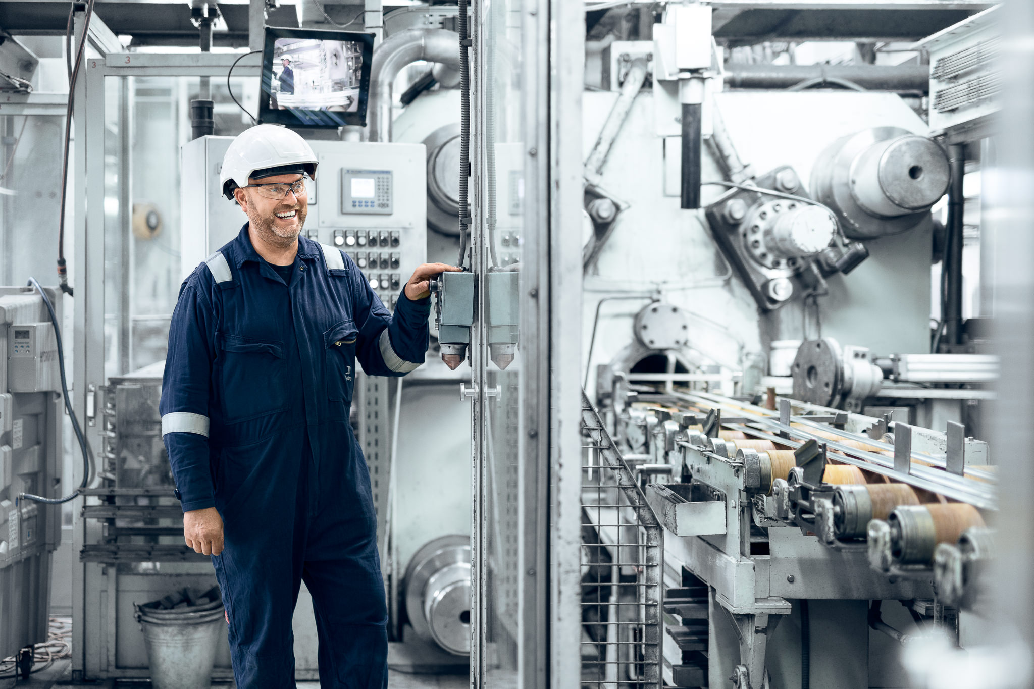 a man in a hard hat working in a factory