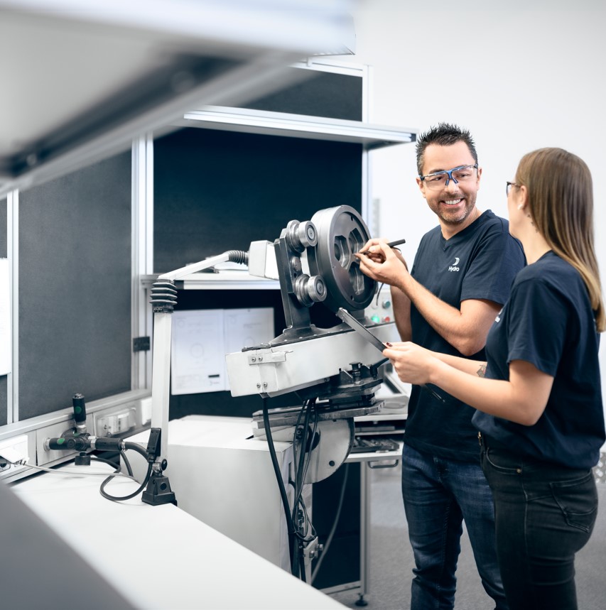 a man and a woman looking at a machine