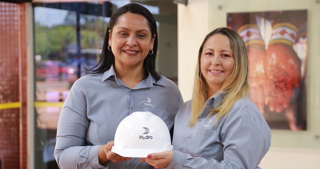 a couple of women holding a white object