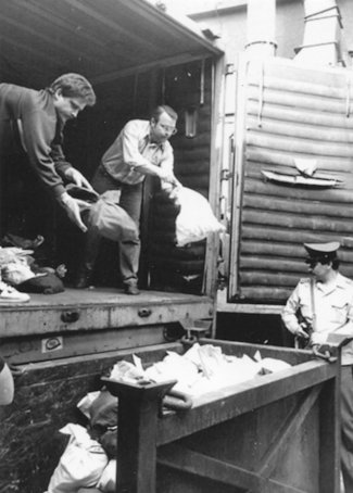 a few men unloading a truck a few men unloading a truck
