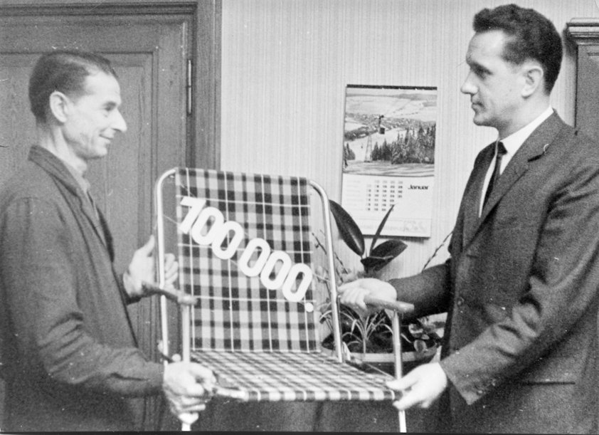 two men holding a chair two men holding a chair