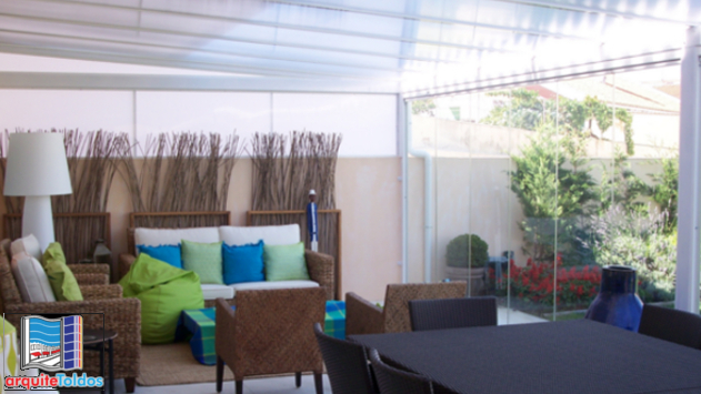 a room with a couch and chairs